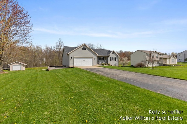 ranch-style home with an attached garage, a front lawn, aphalt driveway, and a residential view