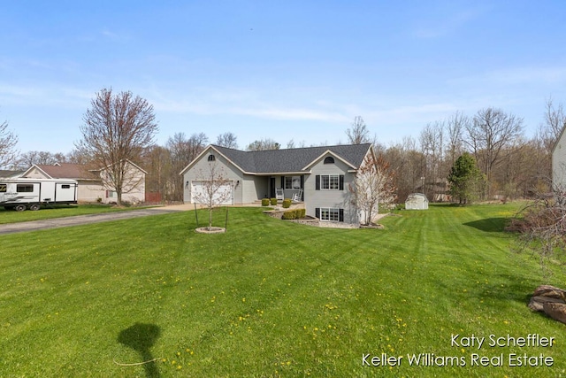 view of front of property featuring an attached garage, driveway, and a front yard