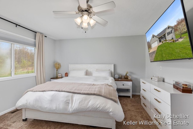 bedroom featuring baseboards, ceiling fan, and carpet