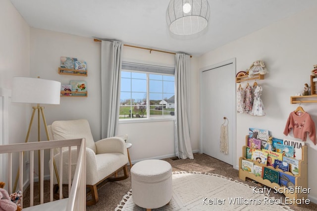 bedroom with carpet floors and a nursery area