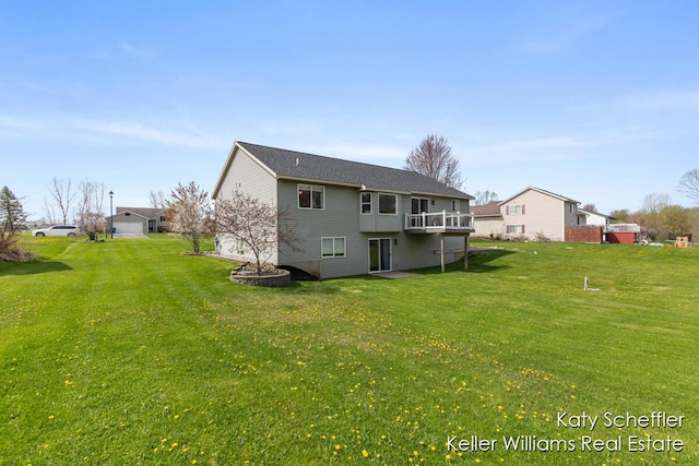 back of property with a wooden deck and a yard