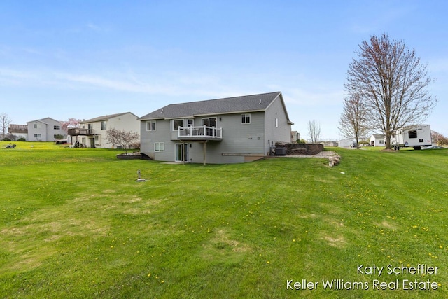 back of house with a yard, central AC, a wooden deck, and a residential view
