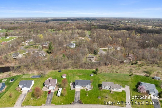 birds eye view of property featuring a view of trees and a residential view