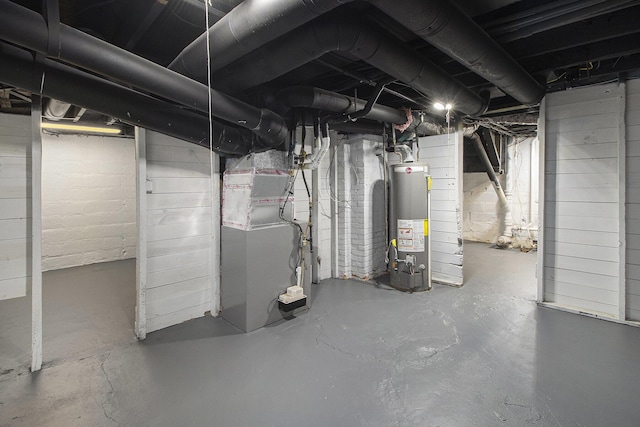 unfinished below grade area featuring heating unit and gas water heater