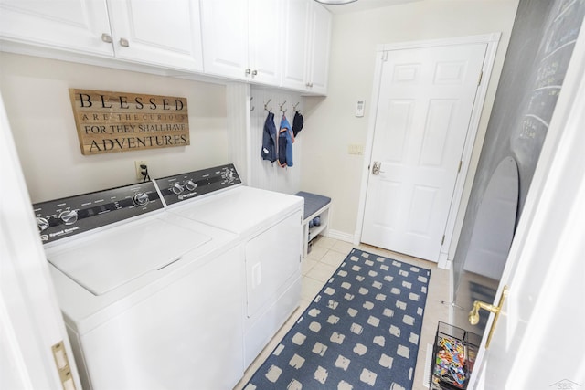 washroom with independent washer and dryer, light tile patterned flooring, baseboards, and cabinet space