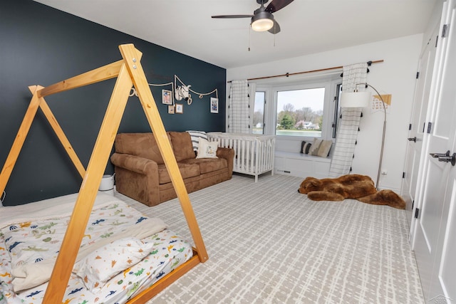 bedroom with a ceiling fan and carpet