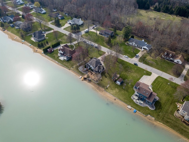 birds eye view of property with a water view, a residential view, and a forest view
