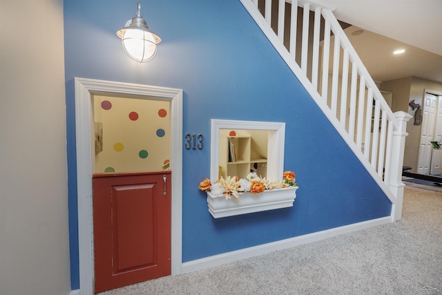 interior space with carpet floors and baseboards