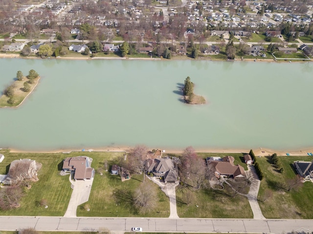 drone / aerial view featuring a water view and a residential view