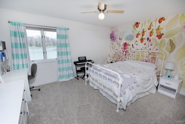 bedroom with baseboards, a water view, a ceiling fan, and carpet flooring