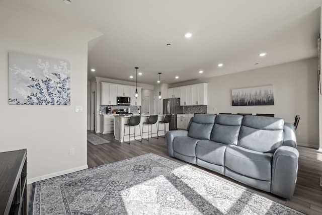living area with baseboards, recessed lighting, and dark wood-style floors