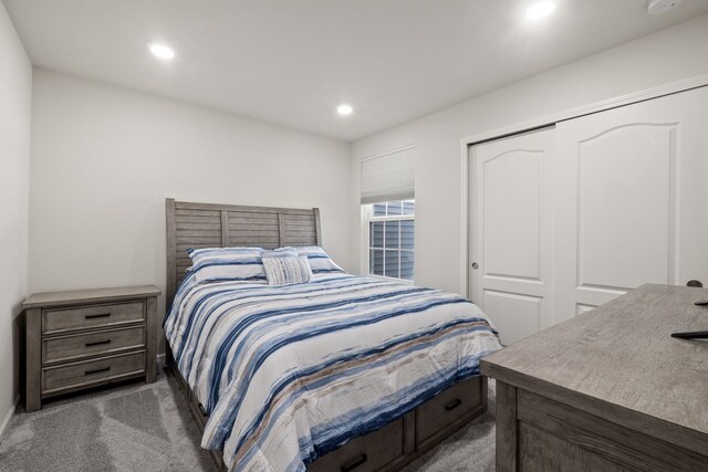 carpeted bedroom featuring a closet and recessed lighting