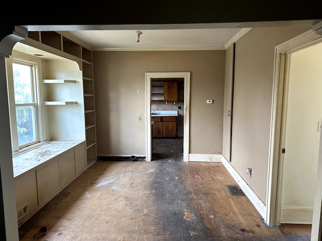 interior space featuring visible vents, ornamental molding, and wood finished floors