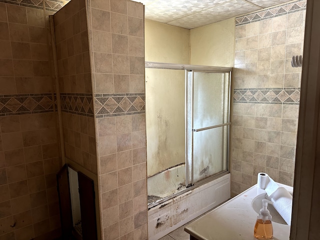 full bathroom featuring tile walls and a tile shower