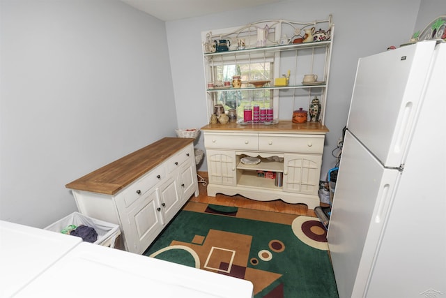 bedroom featuring freestanding refrigerator