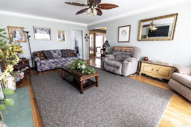 living room featuring ornamental molding, ceiling fan, and wood finished floors