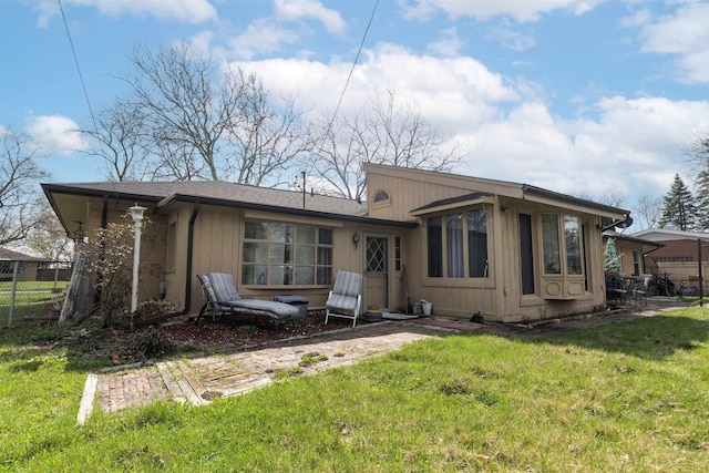 back of property with fence and a yard
