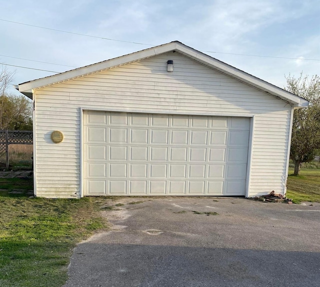 detached garage featuring fence