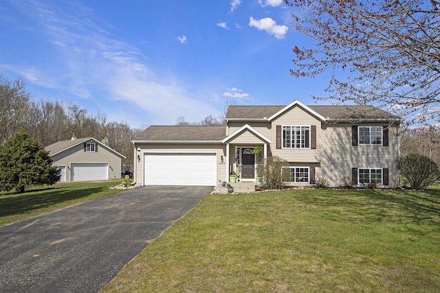 1077 Sun Valley Ln, Allegan, MI 49010 - tri-level home with a garage, a front yard, and aphalt driveway