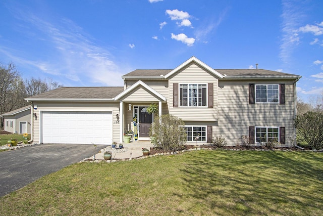 1077 Sun Valley Ln, Allegan, MI 49010 - view of front facade featuring an attached garage, a front lawn, and aphalt driveway