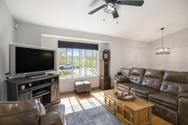 1077 Sun Valley Ln, Allegan, MI 49010 - living room with vaulted ceiling, ceiling fan with notable chandelier, and light wood-style floors