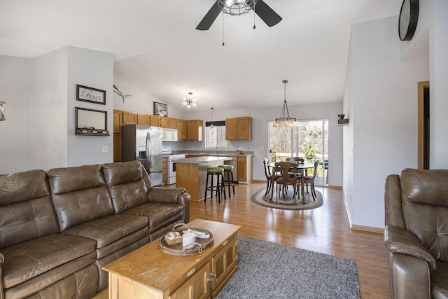 1077 Sun Valley Ln, Allegan, MI 49010 - living area with a ceiling fan, baseboards, lofted ceiling, and light wood finished floors