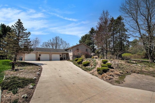 view of front of house with concrete driveway and an attached garage