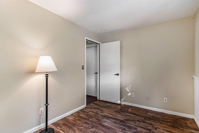 17653 Hiawatha Dr, Spring Lake, MI 49456 - unfurnished bedroom with dark wood finished floors and baseboards