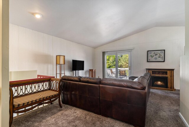 17653 Hiawatha Dr, Spring Lake, MI 49456 - living area featuring lofted ceiling, carpet floors, and a warm lit fireplace