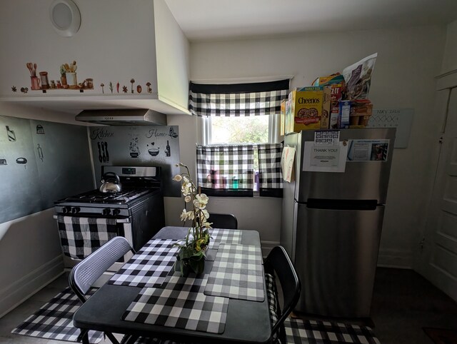 162 Perkins St, Pontiac, MI 48342 - kitchen featuring freestanding refrigerator, gas stove, wall chimney exhaust hood, and baseboards