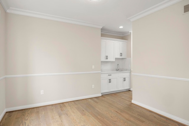 interior space featuring recessed lighting, baseboards, and light wood finished floors