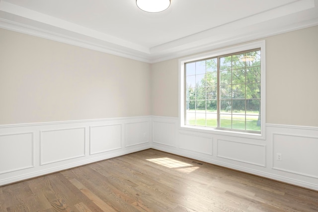1685 E Wattles Rd, Troy, MI 48085 - unfurnished room with a decorative wall, wainscoting, visible vents, and wood finished floors