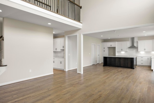 1685 E Wattles Rd, Troy, MI 48085 - unfurnished living room featuring baseboards, a sink, and wood finished floors
