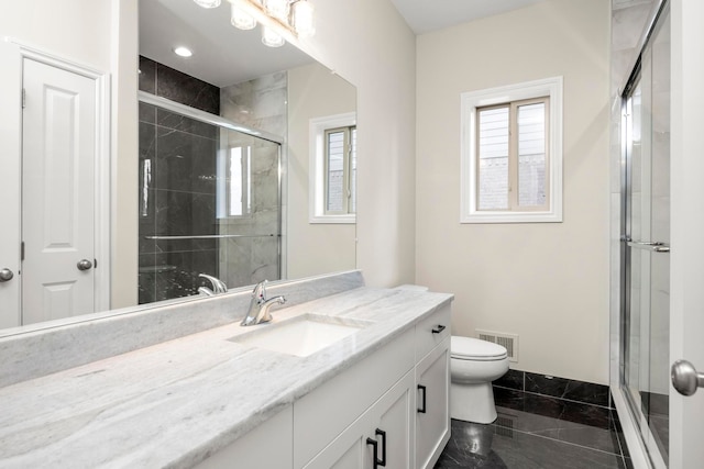 bathroom featuring vanity, a stall shower, toilet, and marble finish floor
