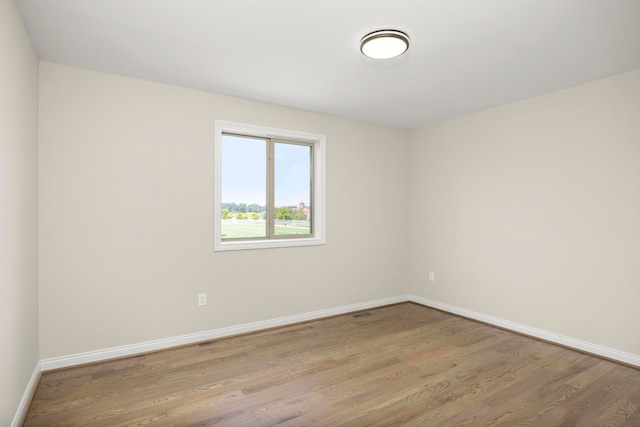 1685 E Wattles Rd, Troy, MI 48085 - spare room featuring wood finished floors and baseboards