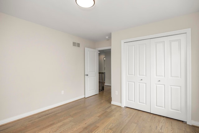 1685 E Wattles Rd, Troy, MI 48085 - unfurnished bedroom with a closet, light wood-type flooring, visible vents, and baseboards
