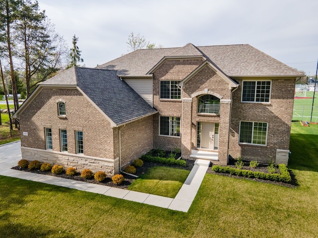 1685 E Wattles Rd, Troy, MI 48085 - traditional home featuring a front lawn, brick siding, and roof with shingles