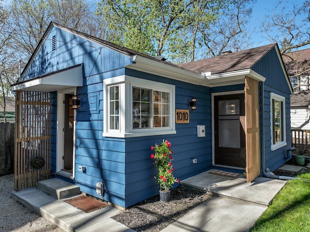 exterior space featuring roof with shingles