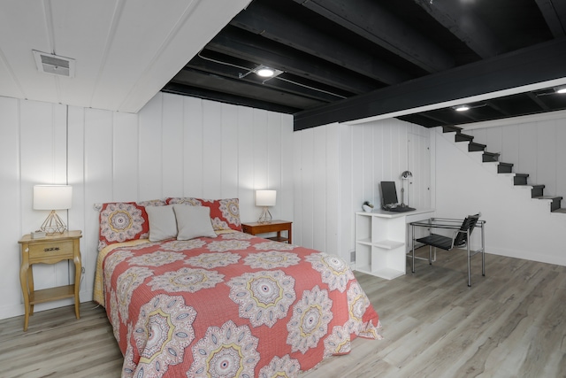 bedroom with visible vents and wood finished floors