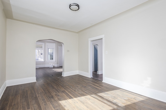574 Melbourne St, Detroit, MI 48202 - unfurnished room featuring wood-type flooring, arched walkways, and baseboards