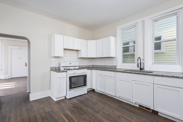 574 Melbourne St, Detroit, MI 48202 - kitchen featuring dark wood-type flooring, a sink, dark stone counters, and white gas range