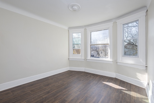 574 Melbourne St, Detroit, MI 48202 - spare room featuring dark wood-style flooring, baseboards, and a wealth of natural light