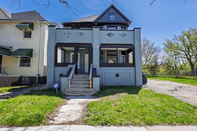 574 Melbourne St, Detroit, MI 48202 - townhome / multi-family property with brick siding, fence, and a front yard