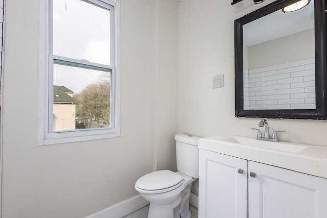 574 Melbourne St, Detroit, MI 48202 - bathroom with toilet, baseboards, a healthy amount of sunlight, and vanity
