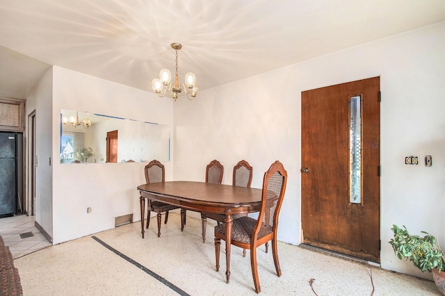 dining space featuring an inviting chandelier, visible vents, and light speckled floor