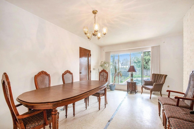 dining area with a chandelier and light speckled floor