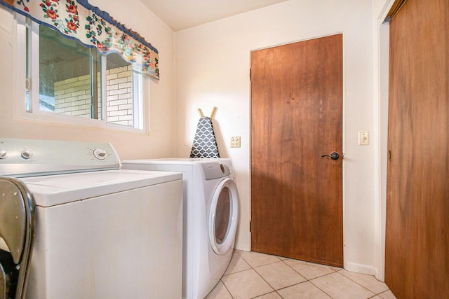clothes washing area with separate washer and dryer, laundry area, and light tile patterned floors