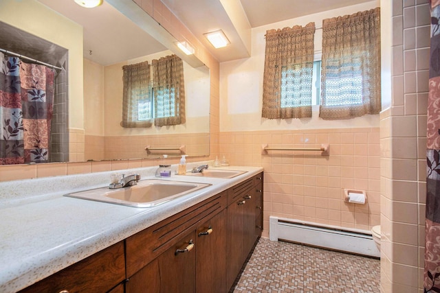 full bath with a shower with curtain, tile walls, wainscoting, vanity, and a baseboard heating unit