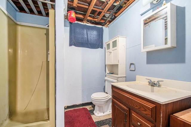 bathroom featuring toilet, walk in shower, and vanity