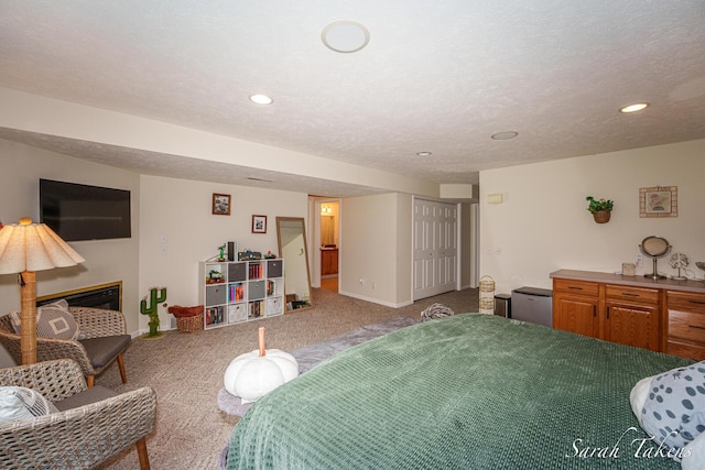 bedroom with baseboards, light carpet, fridge, and recessed lighting